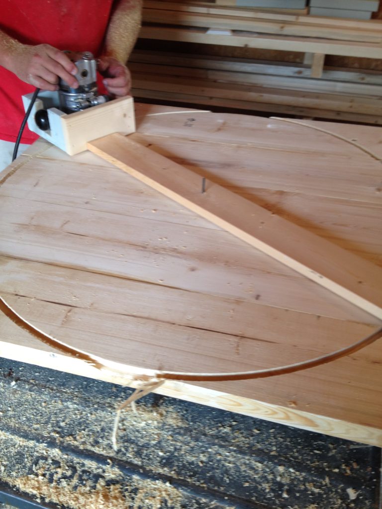 Using router and circle jig to cut round table top from glued up panel