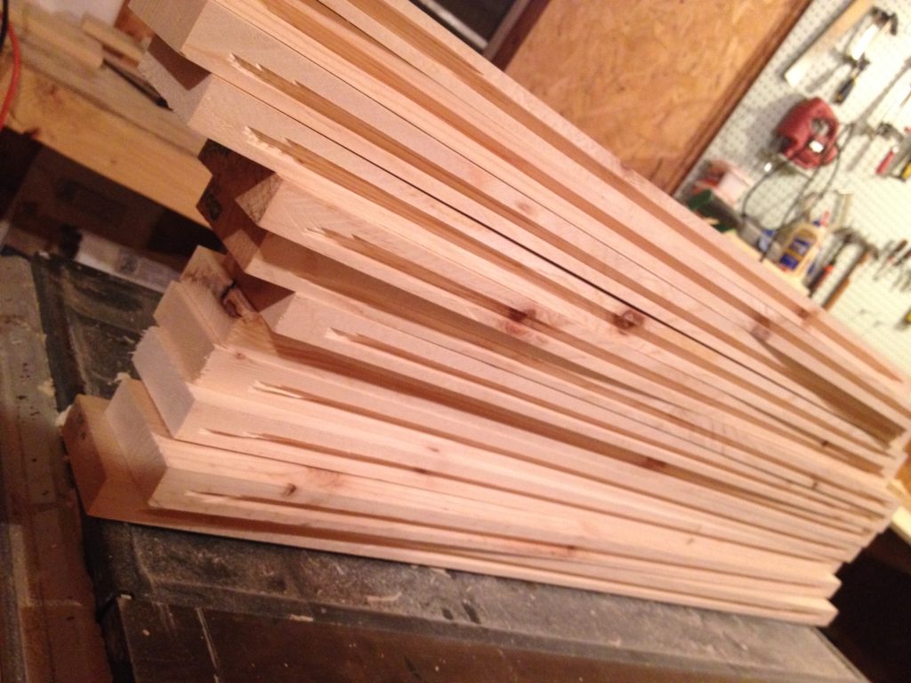 Stack of cabinet door frame pieces with ¼" dadoes cut for panels