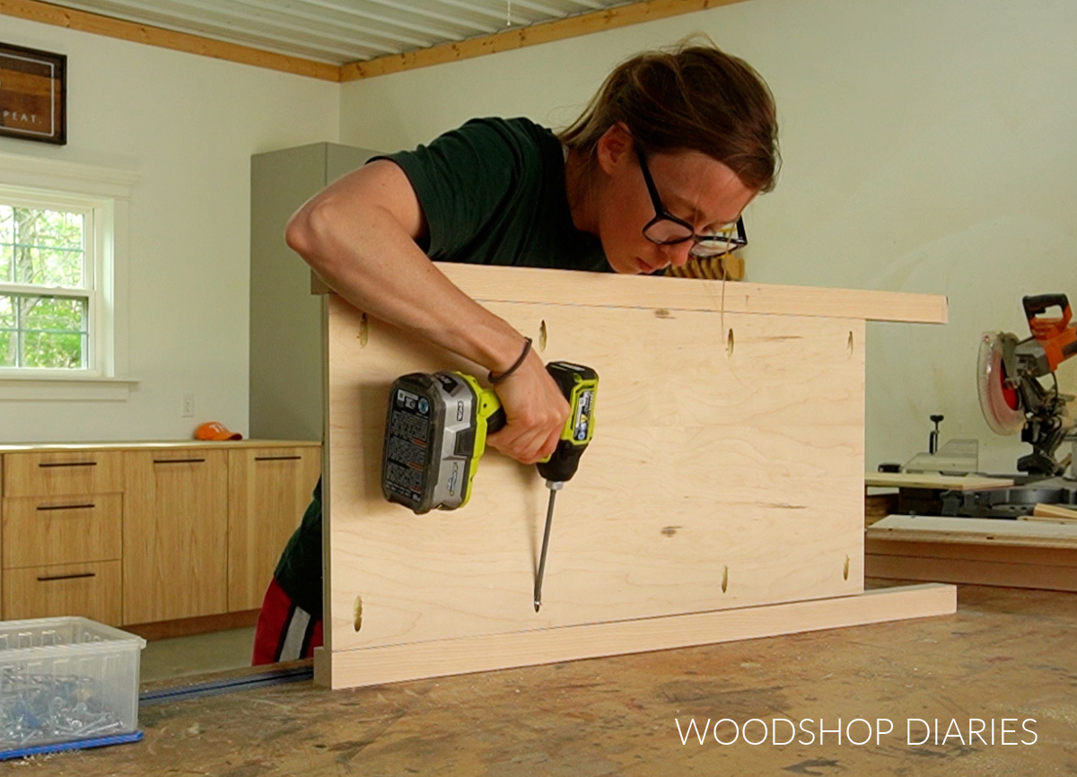 Shara Woodshop Diaries assembling side panels between coffee bar storage cabinet legs using pocket holes