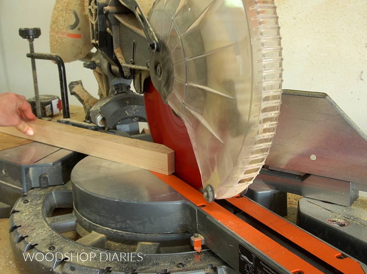 Close up of miter saw cutting tapers on cabinet legs