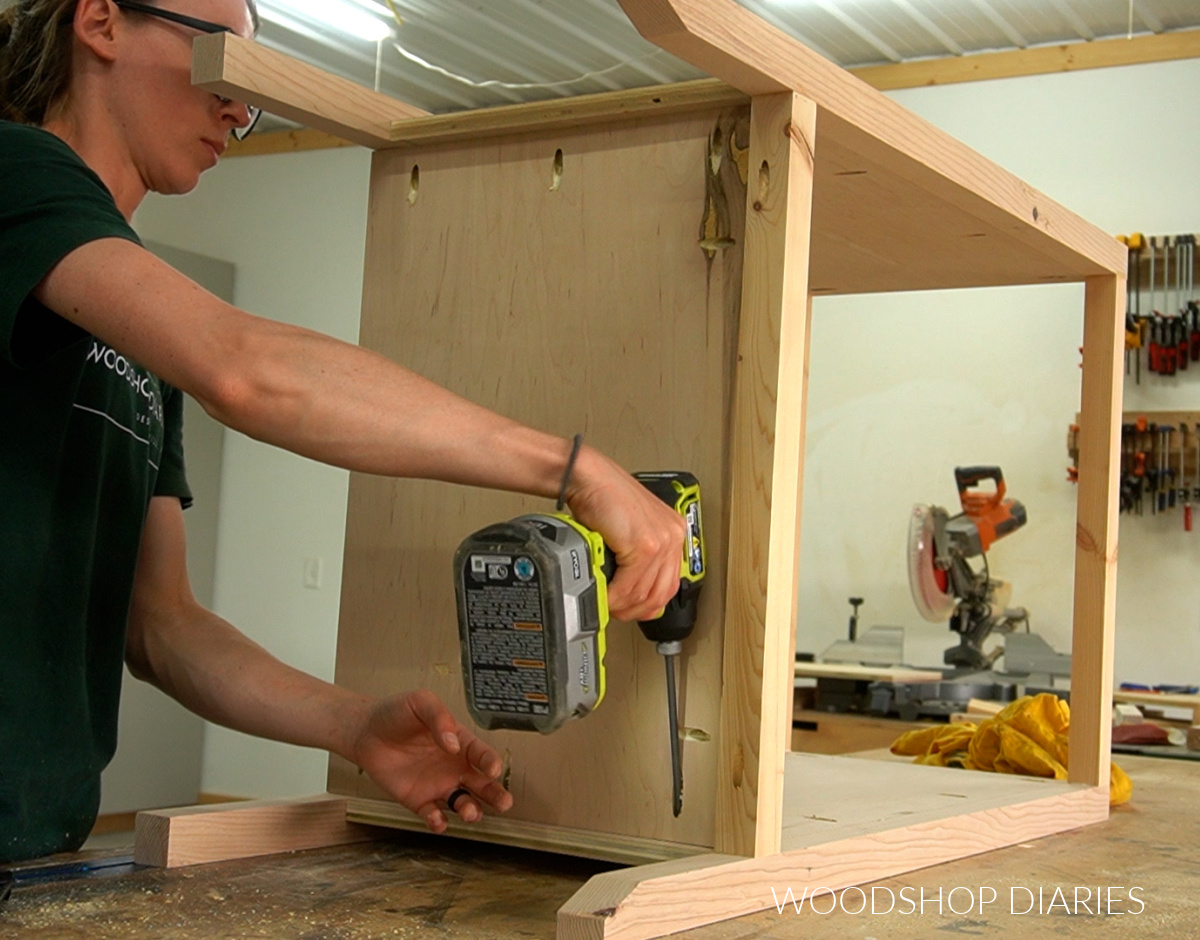 Shara Woodshop Diaries adding bottom panel of coffee storage cabinet using pocket holes