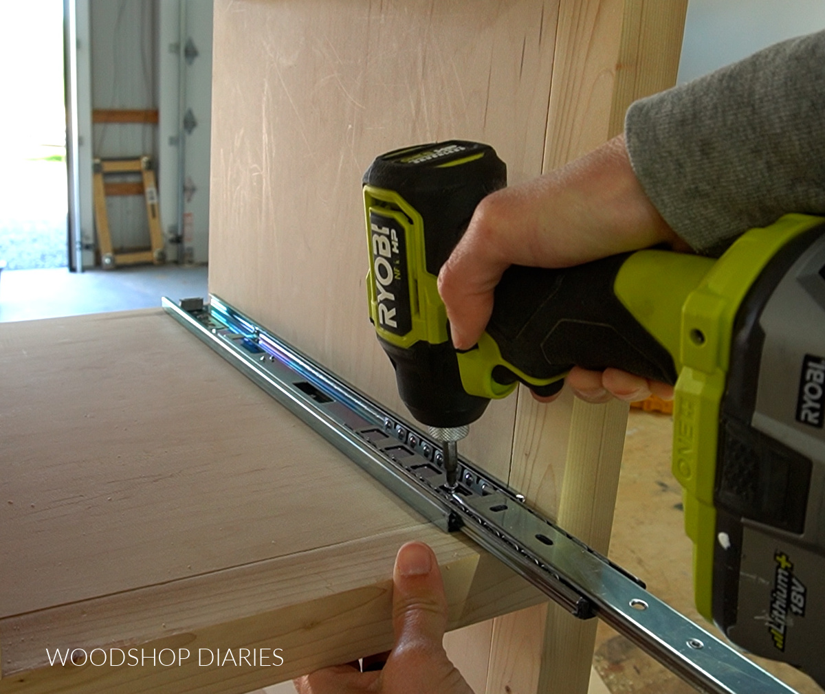 Driving screws to install drawer slides into storage cabinet