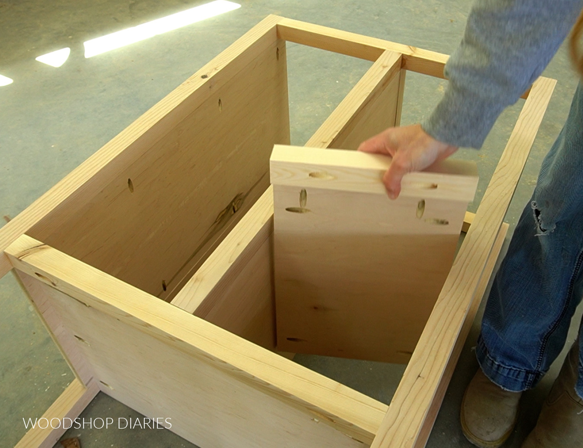 Placing stationary shelf assembly into right side of cabinet above drawer