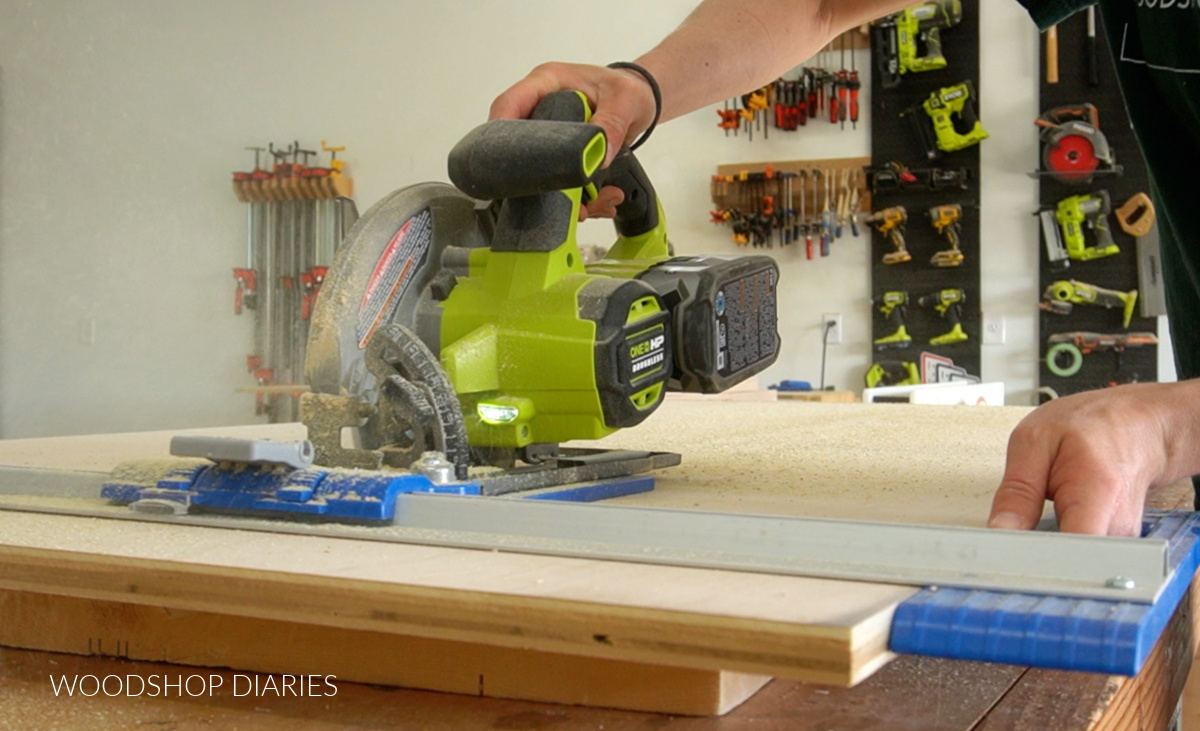 Shara Woodshop Diaries using a circular saw and Kreg Rip cut to cut down plywood sheet on workbench