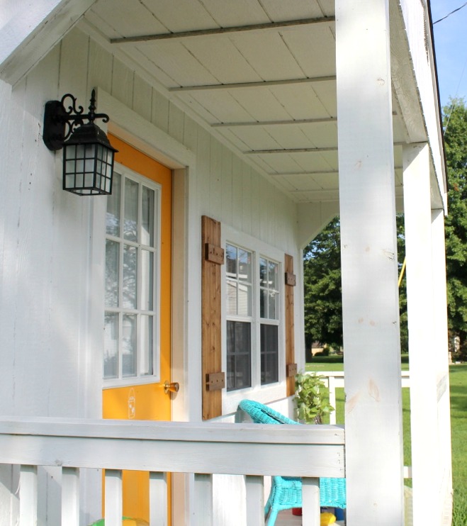 Shutters on front porch of she shed building--wooden shutters hung on each side of front window