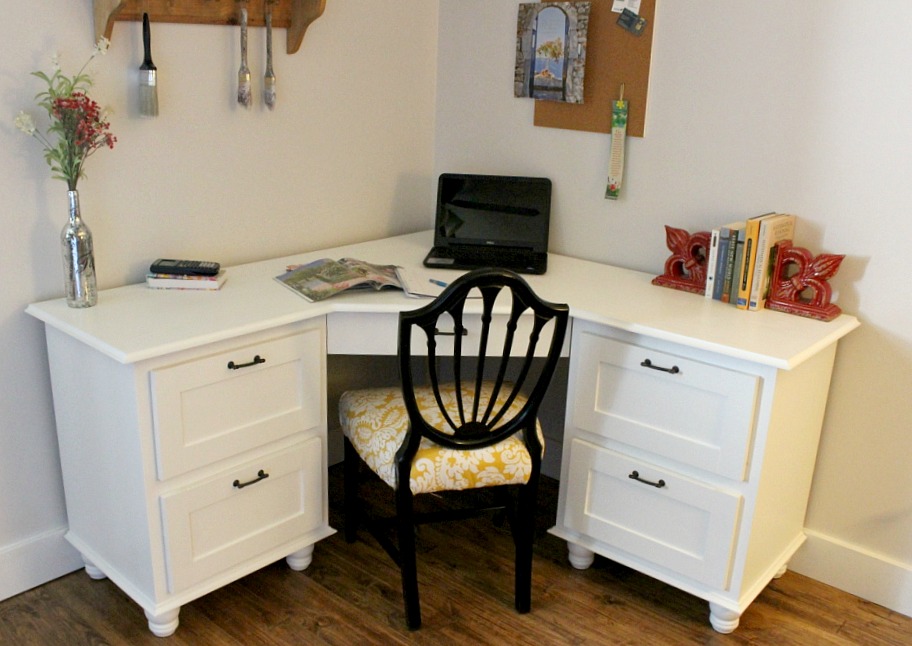 White painted DIY corner desk with trim molding and furniture feet--professional looking corner desk