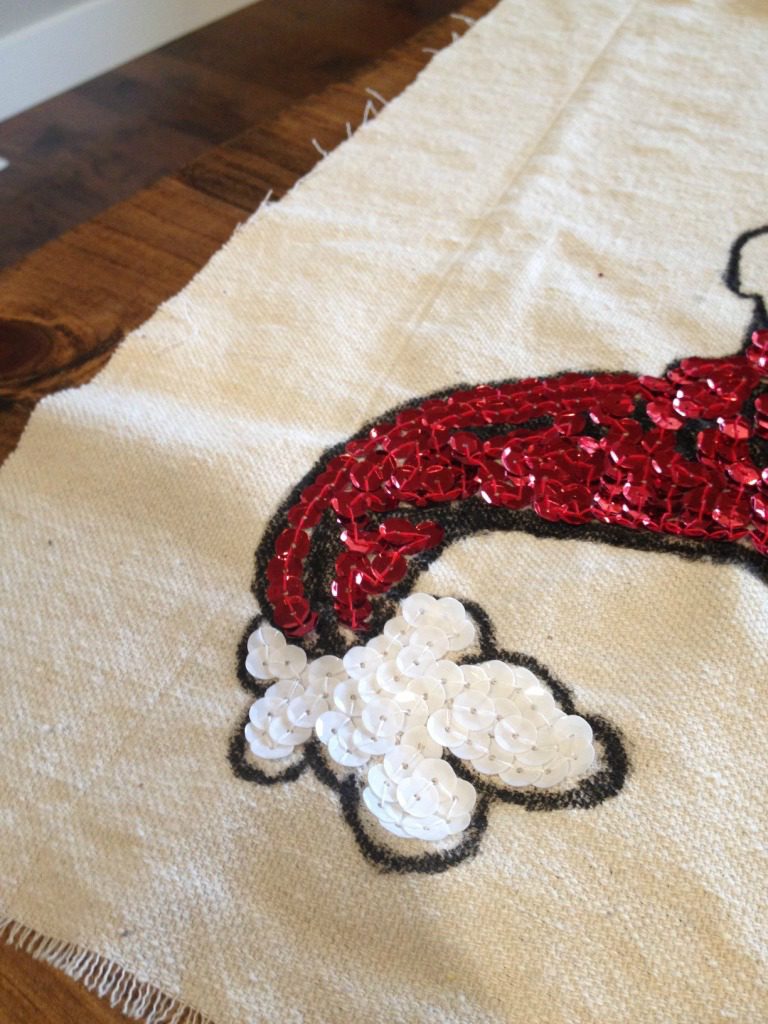 Close up of red and white sequins on drop cloth material