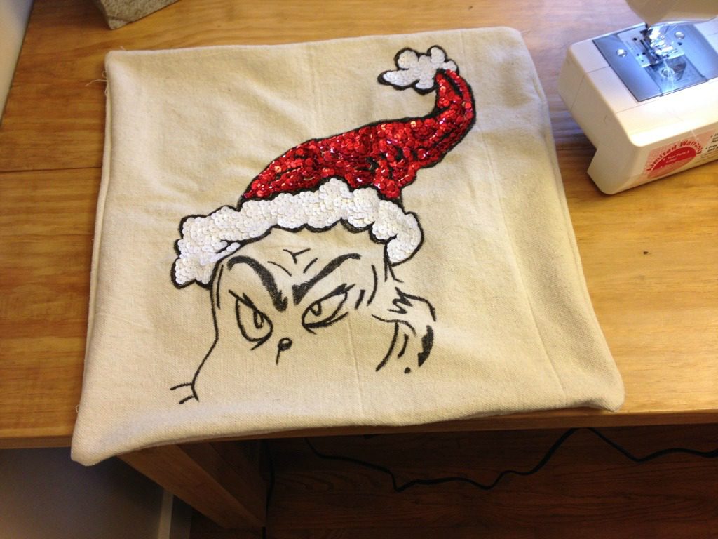 Finished pillow cover laying on worktable 