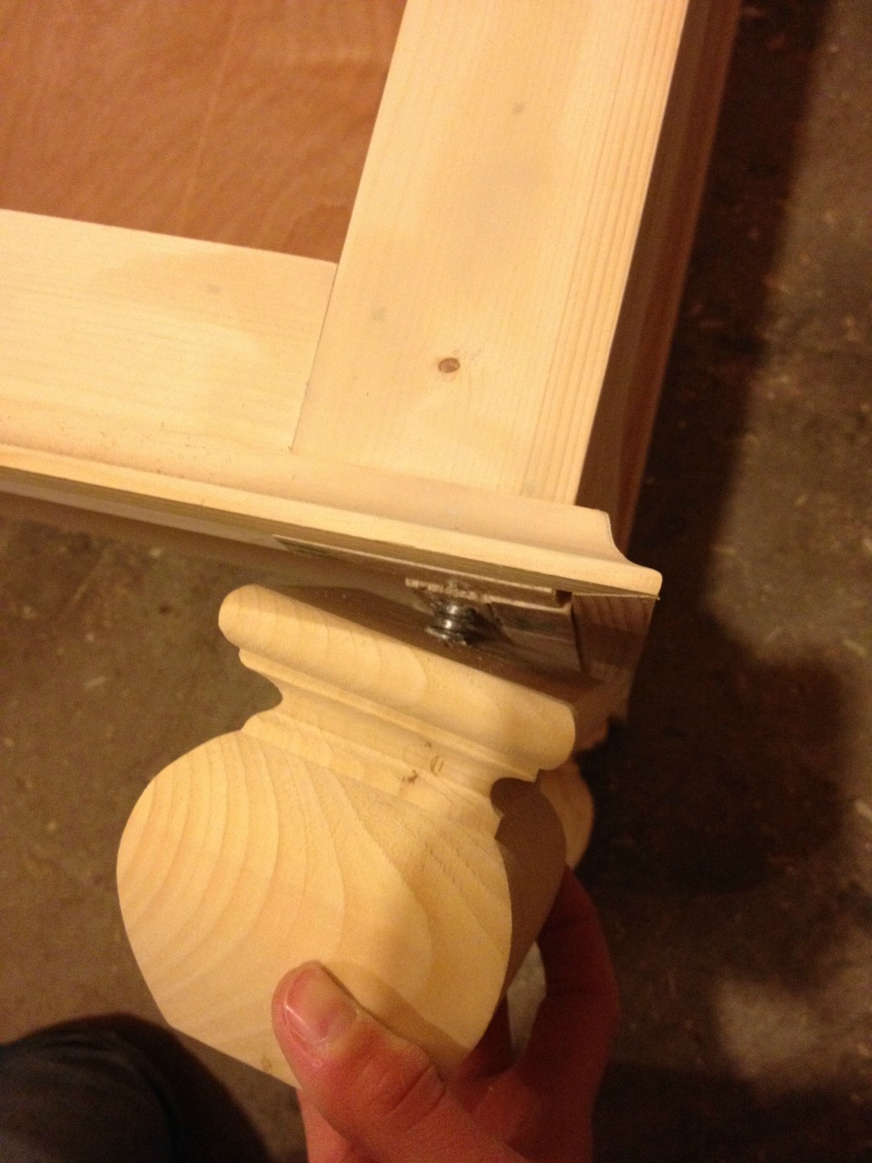 Installing feet onto bookshelf using screw dowel