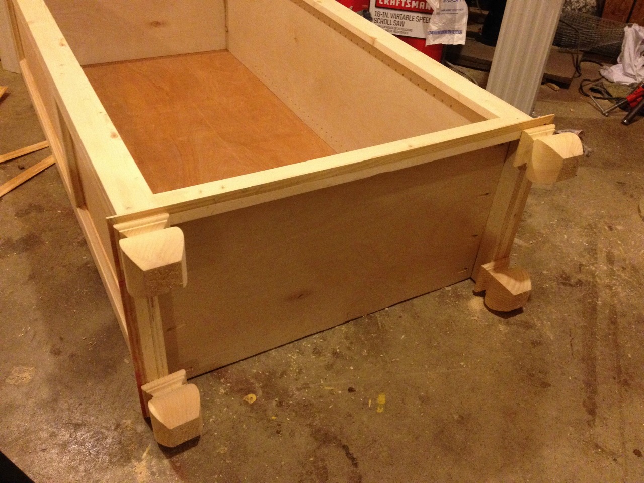 Feet attached to tall freestanding bookshelf--lying on its back in workshop