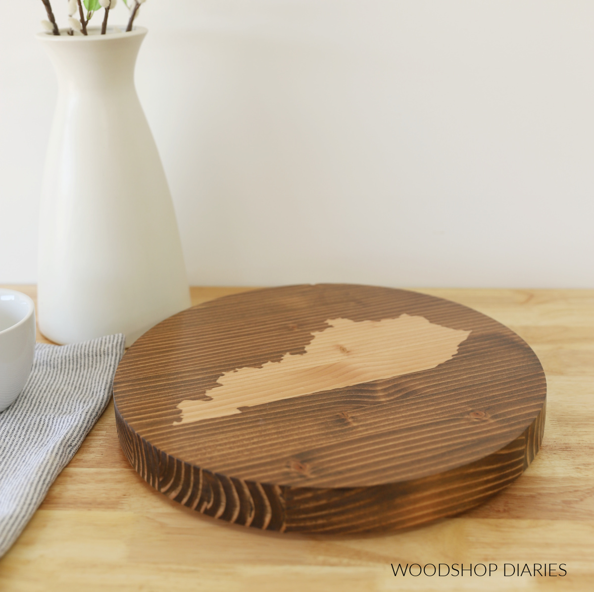 Round wooden lazy susan with Kentucky shape stained on top