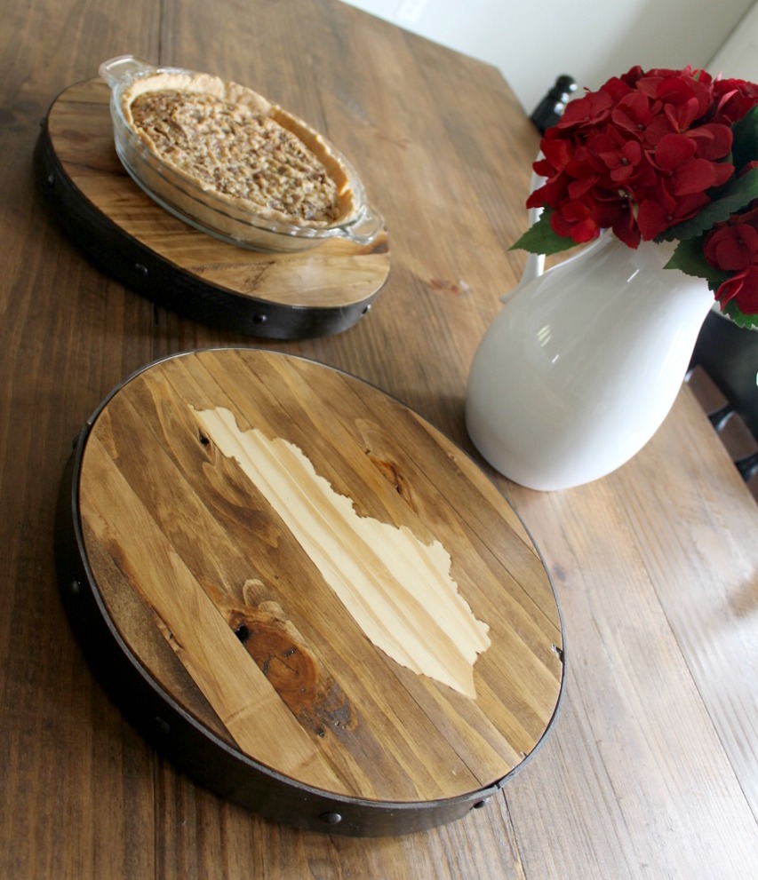 Wooden lazy susans on table with faux metal band around edges