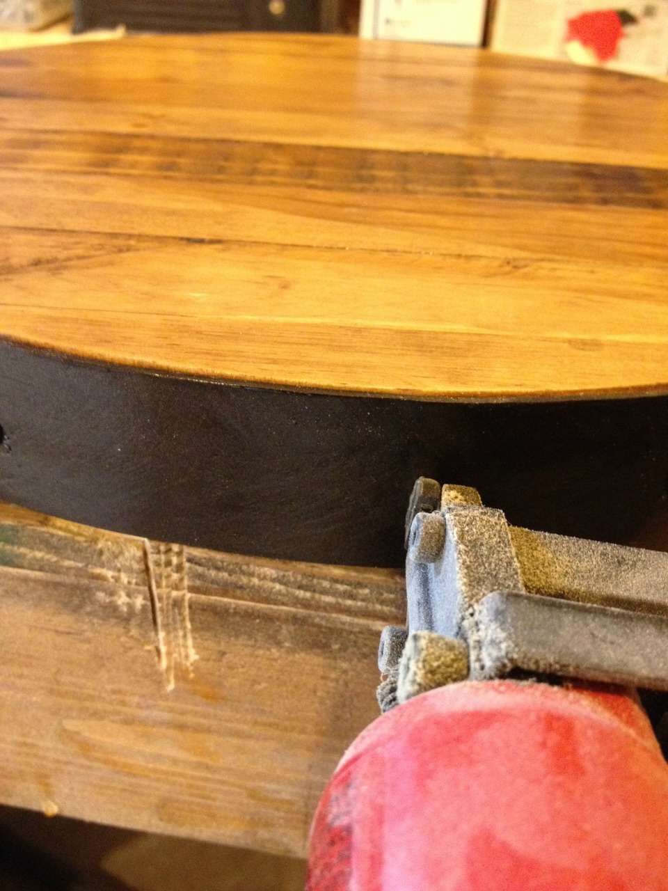 Using a stapler to attach fake metal band around wooden lazy susan