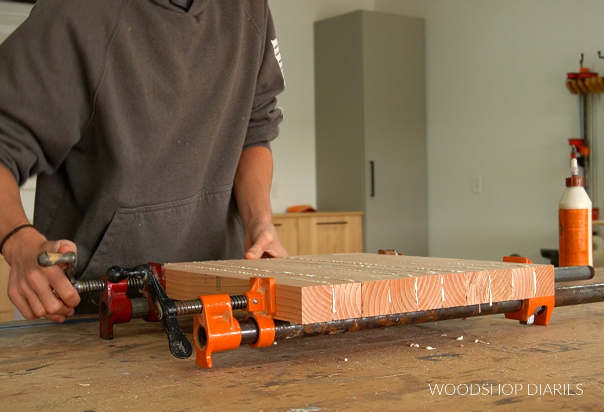 Clamping 2x2s together into a panel on workbench in pipe clamps