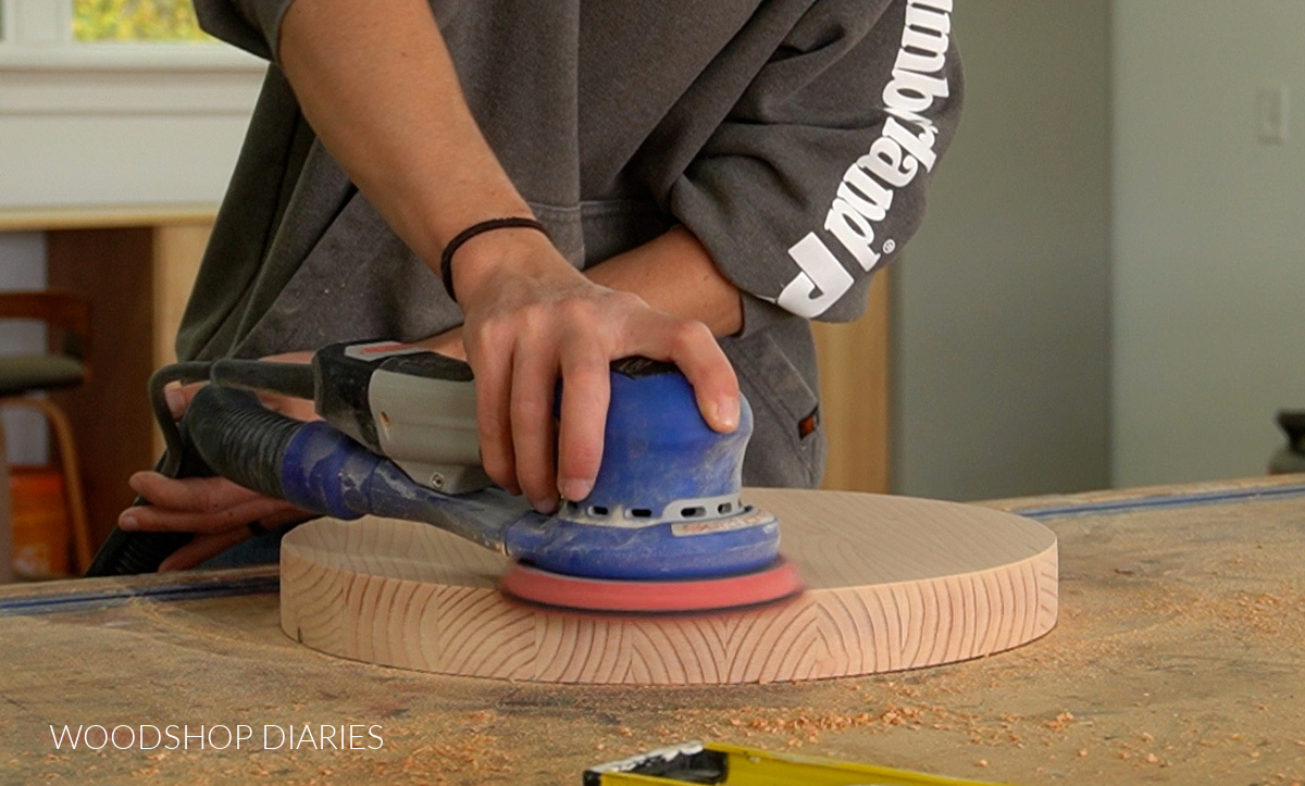 Shara Woodshop Diaries using orbital sander to sand round wooden lazy susan