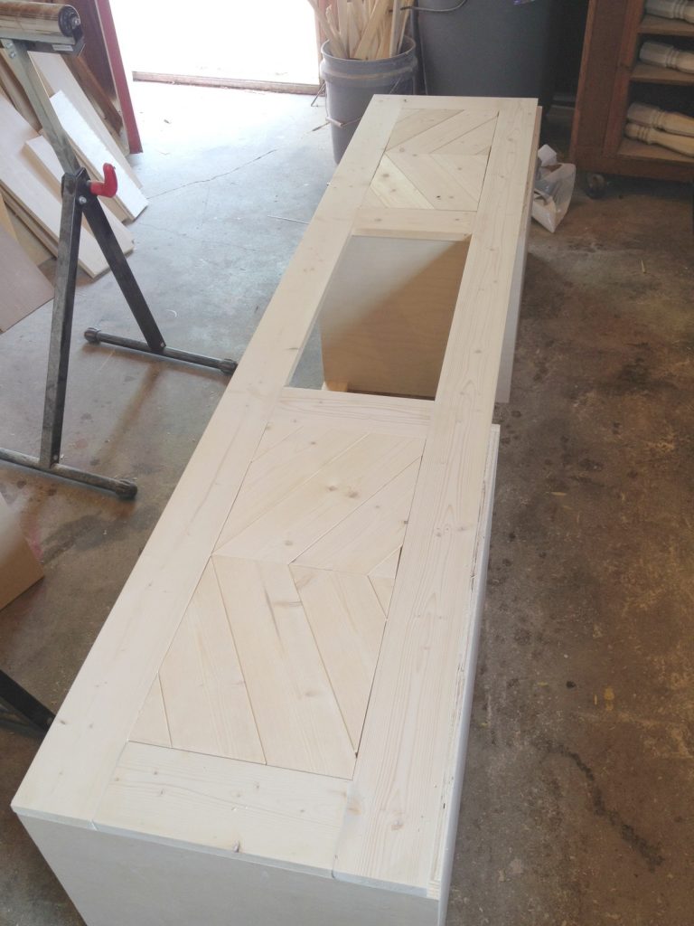 Chevron wood cut outs added to built in shoe bench fronts