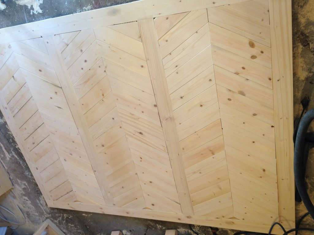 Chevron wood pieces added to Mudroom built in wall backer