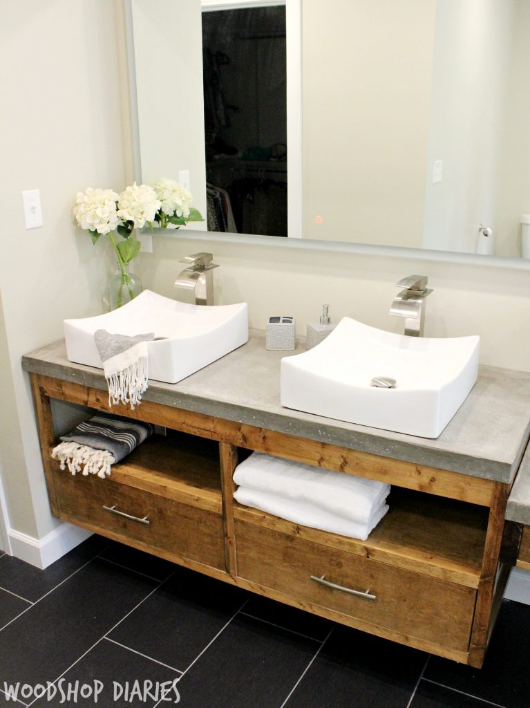 Modern Bathroom with concrete counter tops, vessel sinks, and silver finishes. Gorgeous modern style bathroom