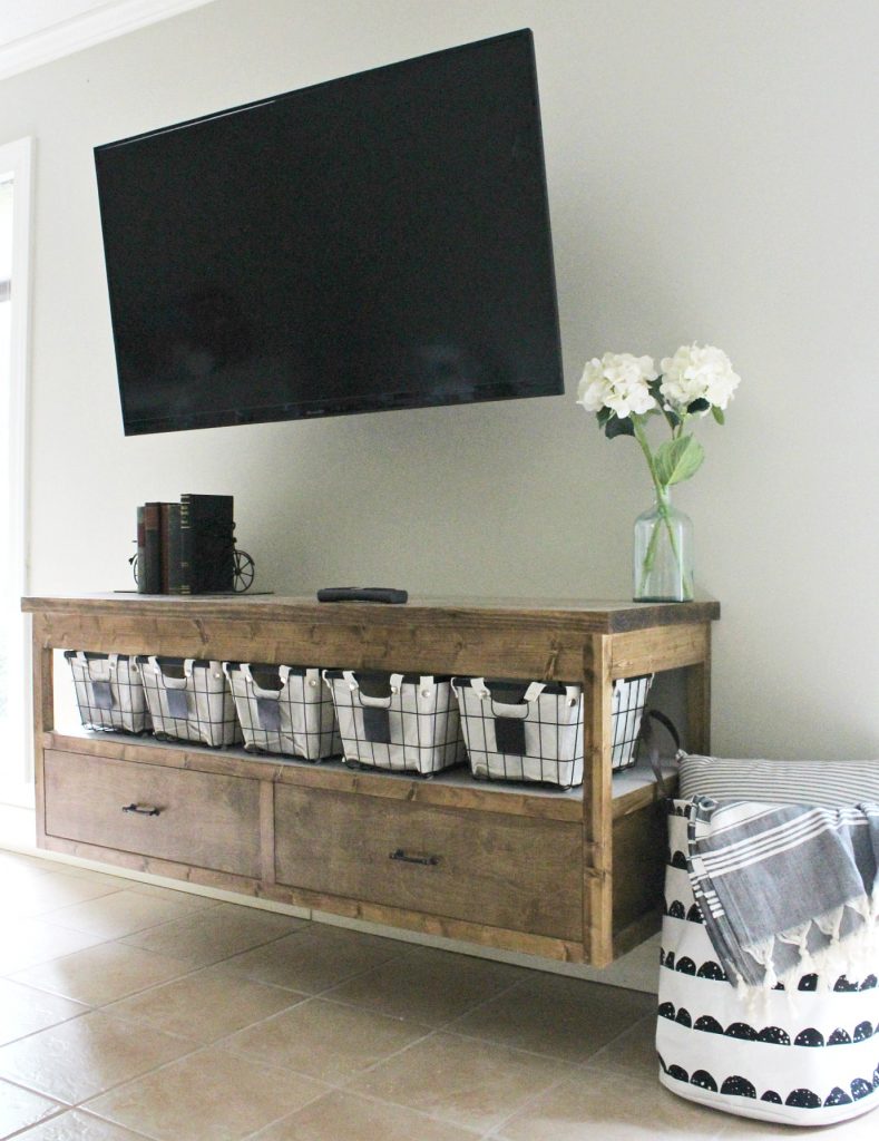 Free building plans to build your own modern DIY TV Console table. With plenty of storage, plus functionality, this modern TV Console is easy to build and stained in a gorgeous minwax provincial. Perfect for a living room, kids playroom, or even a bedroom.