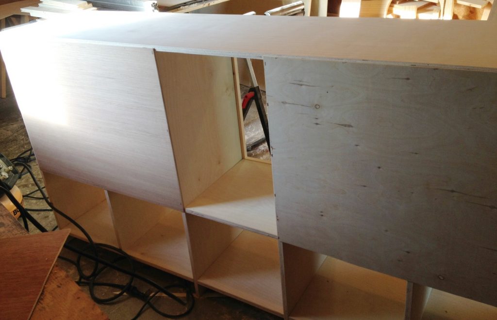 Staple plywood backer onto DIY storage console cabinet