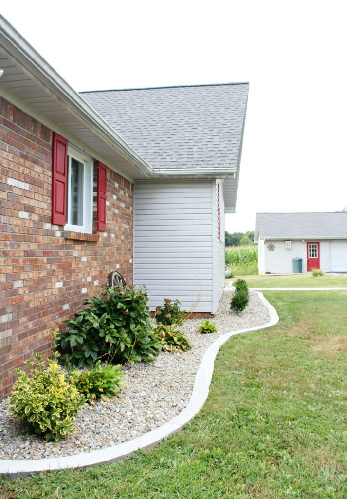 Modern landscape with concrete edging and Indiana river rock really improves home's curb appeal