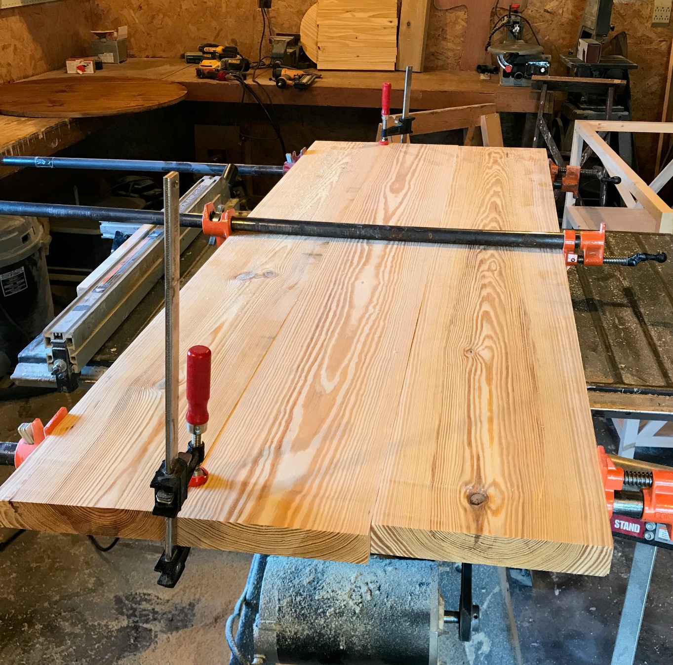 Table top glued up on table saw for X base console table