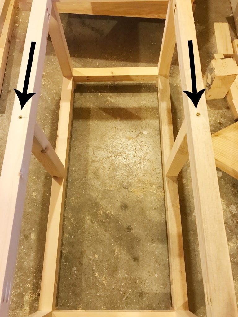 Screw middle dividers into DIY storage chest frame