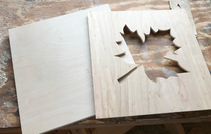 Two pieces of plywood, one with leaf cutout for DIY scrap wood fall sign.