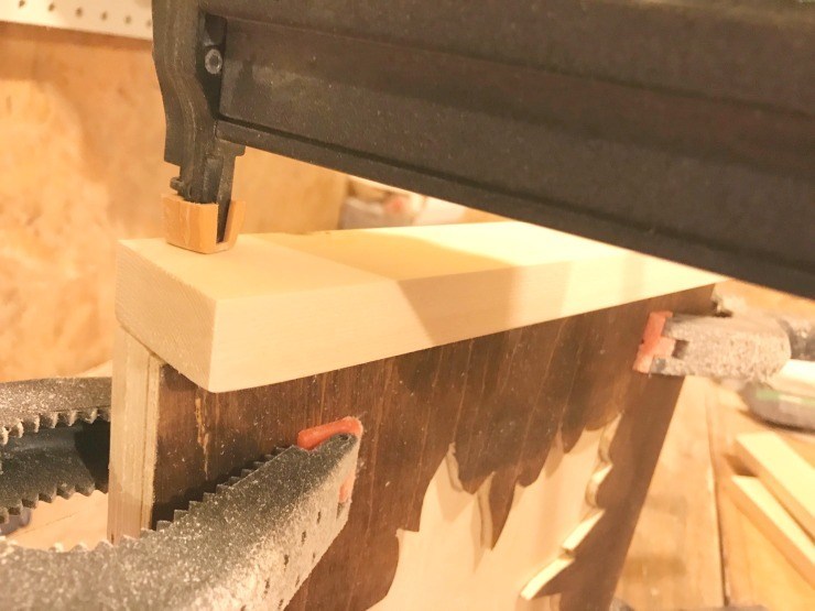 Adding frame to DIY scrap wood fall sign with nail gun.