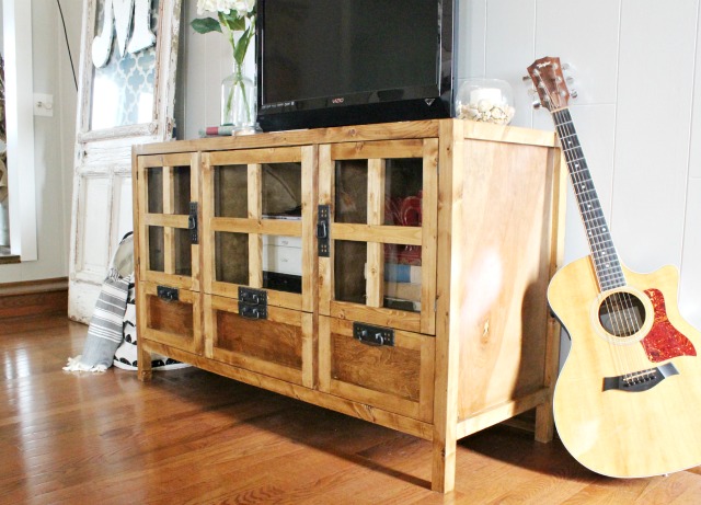 How to build a modern DIY media console cabinet with glass doors, and drawers for storage!