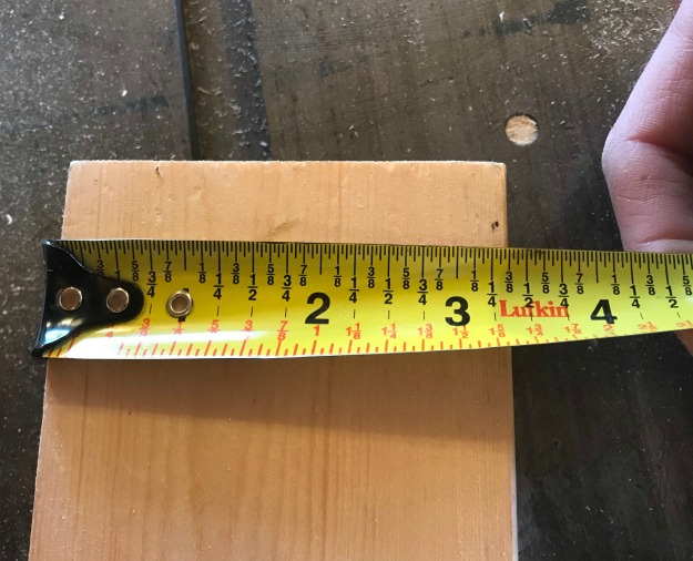 tape measure across 2x4 measuring 3 ⅜"