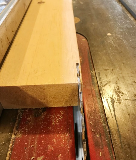 Board on table saw--blade removing ¼" off the edge