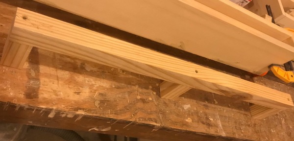 Floating shelf support bracket assembled from 2x2s
