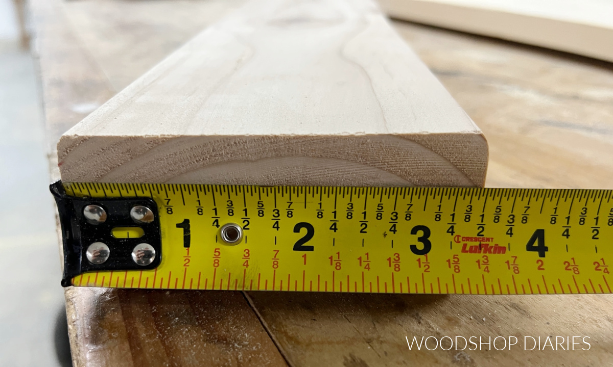 reading a tape measure stretched across a 1x4 board