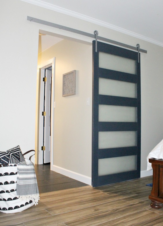 DIY Modern Sliding Door with DIY hardware instructions too! Glass panels make this mid century modern design unique