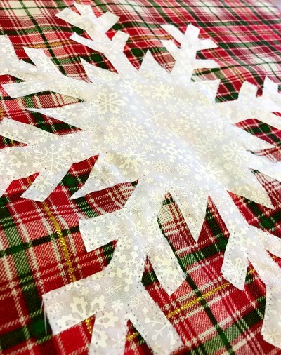 Stitch snowflake onto DIY snowflake pillow