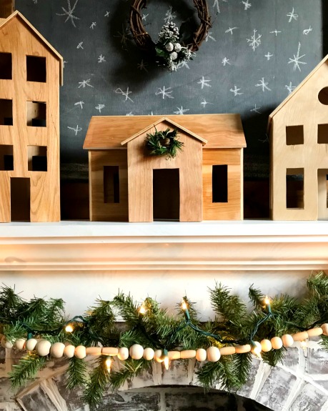 Close up of house in DIY wooden Christmas village.