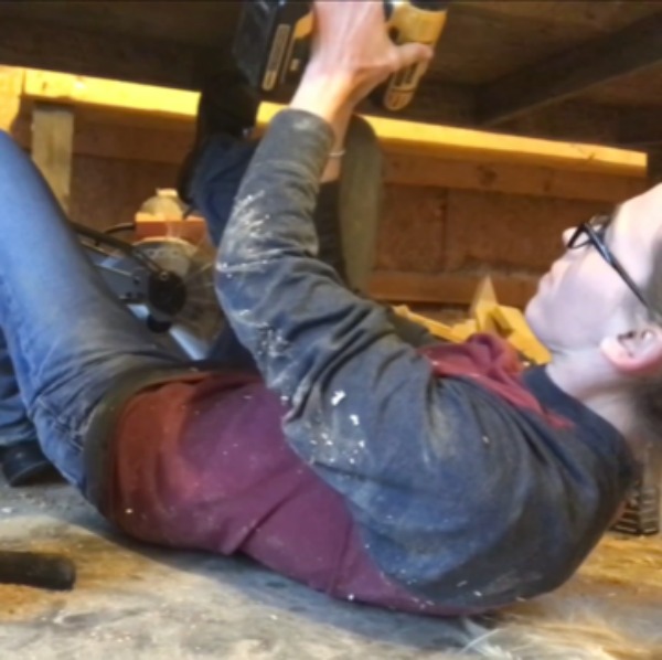 screw table supports in place in barn wood table