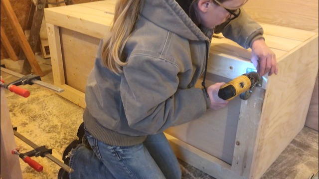 Shara Woodshop Diaries installing caster wheels onto saw station base frame