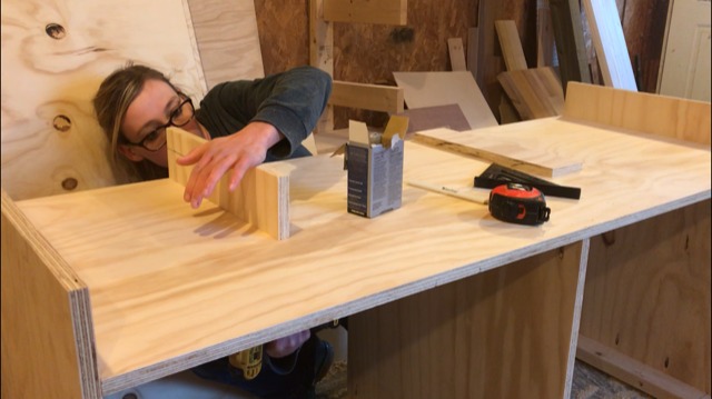 Shara Woodshop Diaries installing cubby supports on top of mobile saw station