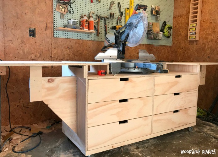 DIY mobile miter saw stand with folding wings extended on each side with large storage drawers