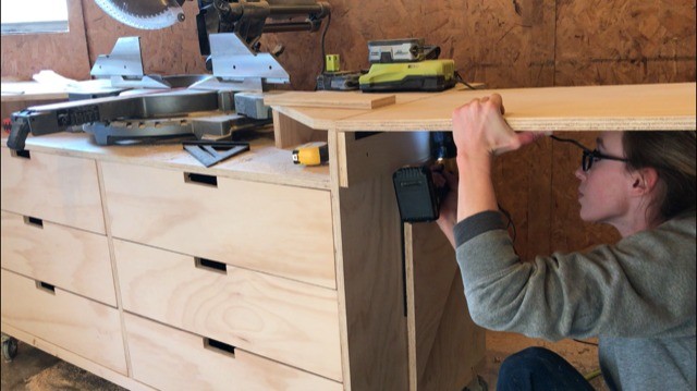 Shara Woodshop Diaries installing foldable wings onto miter saw stand through piano hinges