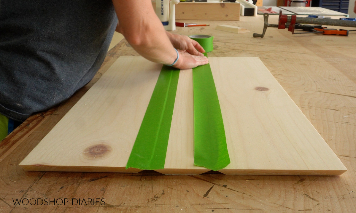 Shara Woodshop Diaries placing tape along joints of wooden shelf box