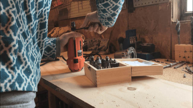 Tightening the nut on trim router to hold bit in place