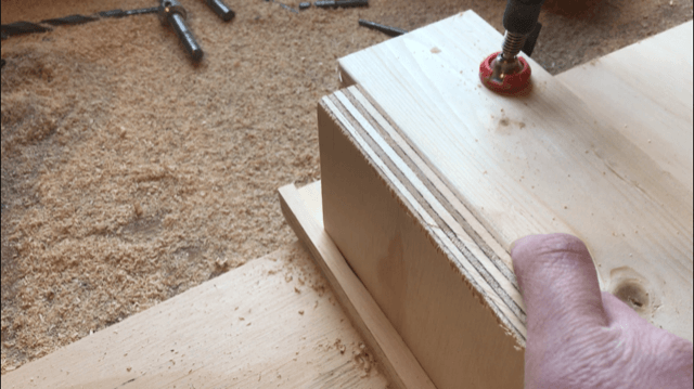 Test fit plywood pieces into dadoes for bookshelf assembly