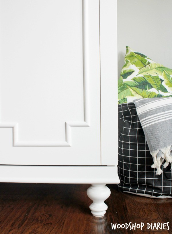 Close up of bottom right corner of DIY armoire cabinet with decorative feet