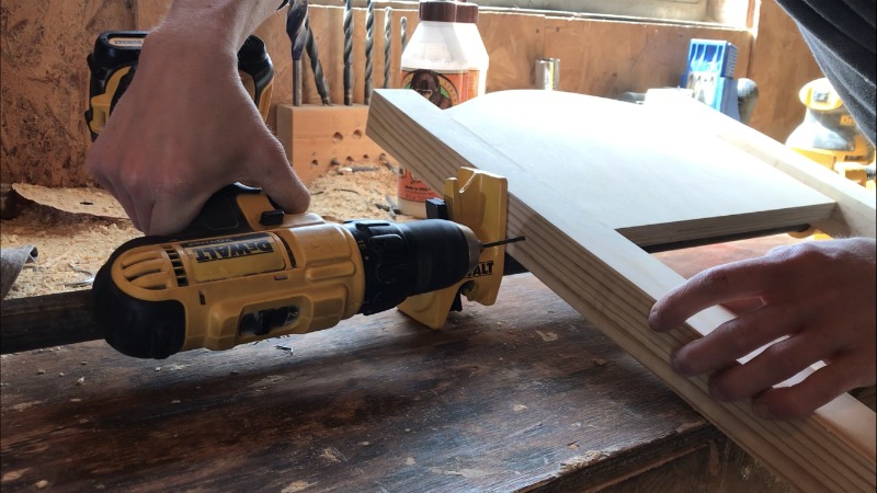 Using a drill to secure back curve panel for wooden kids chair set