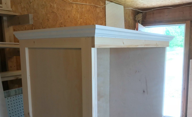 Crown molding installed onto cabinet on top and side
