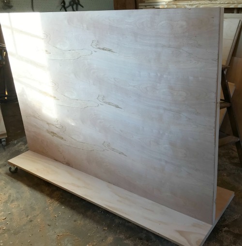 ¼" plywood panel installed onto scrap wood cart divider frame
