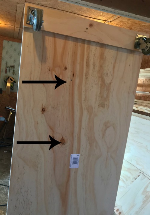 underside view of the bottom plywood panel showing where to install the screws